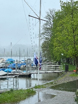 A boat dock in the rain

Description automatically generated